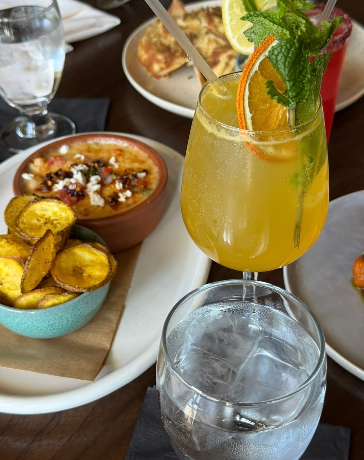 a variety of dishes and a citrus cocktail
